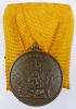 Onderscheidingsteken voor langdurige, eerlijke en trouwe dienst.
Bronzen medaille.